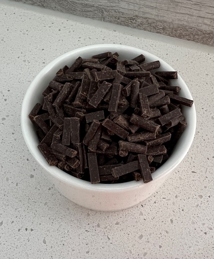 dark chocolate chips in a white bowl